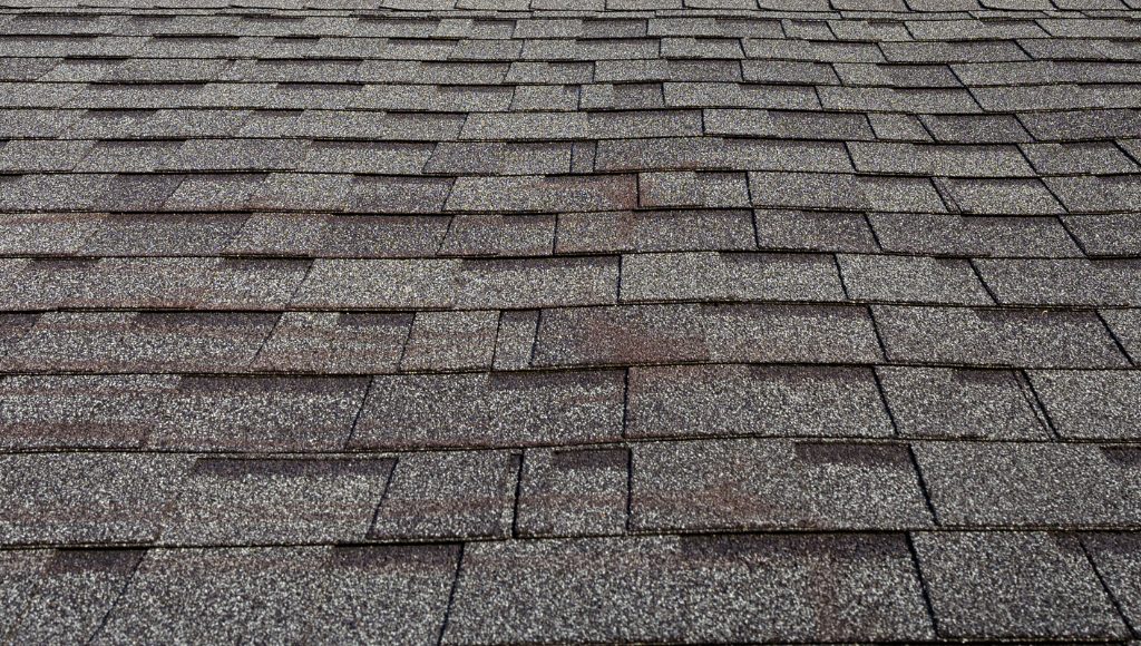 A close-up image of an asphalt shingle roof.